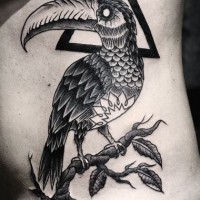Amazing bird with black triangle tattoo on ribs by Daniel Meyer