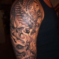 Amazing black and white detailed big on shoulder tattoo of evil dragon and skulls