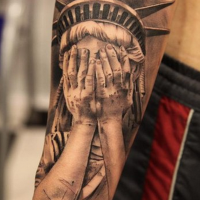Amazing black and white detailed forearm tattoo of crying Statue of Liberty
