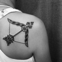 Amazing black ink detailed shoulder tattoo of fantasy bow
