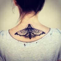Amazing black ink moth tattoo on girls upperback