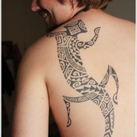 Amazing black patchwork lizard tattoo on back