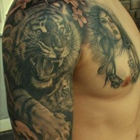 Amazing crouching tiger tattoo on shoulder