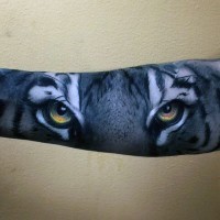 Amazing detailed colorful creepy tiger look tattoo on sleeve