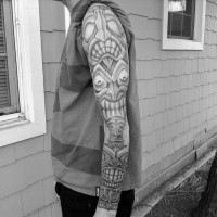 Amazing detailed creepy tribal Gods tattoo on sleeve