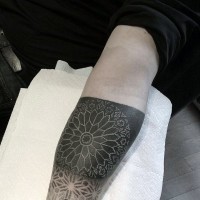 Amazing detailed symbolical white massive flower on black background arm tattoo