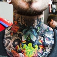 Amazing glowing like colored chrysanthemum flower tattoo on neck with bugs