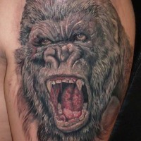 Amazing gray-ink gorilla tattoo on upper arm