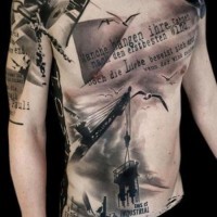 Amazing industrial themed massive black and white tattoo with lettering on chest and shoulder