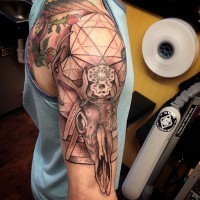 Amazing looking black ink deer skull tattoo on shoulder combined with geometrical figures