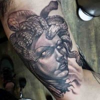 Amazing painted 3D like evil Medusa head tattoo on arm