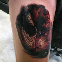 Amazing painted and colored little deep space planet tattoo on thigh