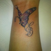 Amazing small butterfly tattoo on wrist with lettering