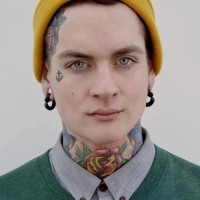 Amazing small face tattoo on mans body