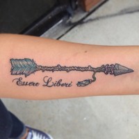 Ancient arrow tattoo with letters on forearm