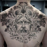 Ancient like black ink detailed back tattoo of ancient man portrait with leaves