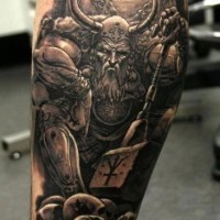 Angry viking and skulls tattoo on leg