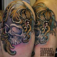 Antic like colored shoulder tattoo of natural looking skull