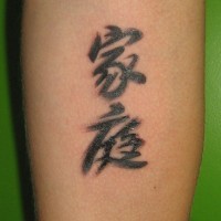 Tattoo am Arm mit chinesischen Symbolen