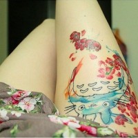 Asian cartoon colored hero tattoo on thigh stylized with red flowers
