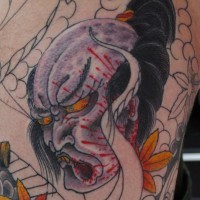 Asian native colored back tattoo of severed demons head