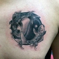 Asian oriental Yin Yang symbol decorated with Pisces tattoo on chest