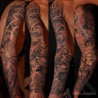 Asian style big black and white mystical dragon with flowers tattoo on arm