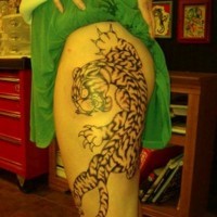 Asian style black and white little tiger tattoo on thigh