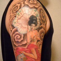 Asian style colored seductive geisha tattoo on shoulder with umbrella