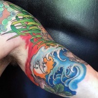 Asian style colored tiger with waves tattoo on biceps