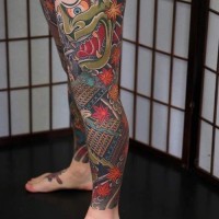 Asian style massive colorful tattoo on whole leg with demonic mask and samurai warrior