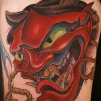 Asian traditional shoulder tattoo of red colored demonic mask