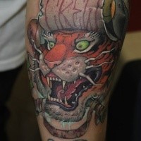 Asian traditional style colored forearm tattoo of tiger head with lettering