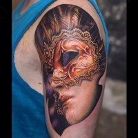 Attractive young mystical lady in ancient mask colored 3D lifelike tattoo on shoulder area