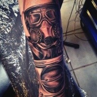 Awesome black and gray style detailed arm tattoo of man in gas mask