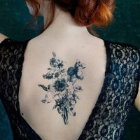 Awesome black bouquet of wildflowers tattoo on back
