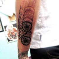 Awesome black ink blur like bicycle tattoo on arm