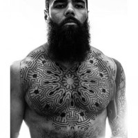 Awesome black ink labyrinth like tribal tattoo on chest and sleeve