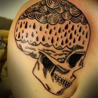 Awesome black ink rain over sea in skull tattoo on shoulder