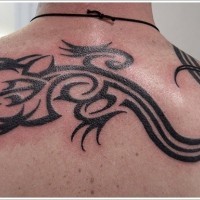 Awesome black ink tribal lizard tattoo on back