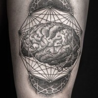 Awesome collage of geometric shapes and brain tattoo on thigh by daniel meyer