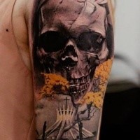 Awesome colored shoulder tattoo of human skull with strange church