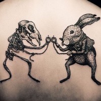 Awesome designed and painted little black ink bunny with skeleton tattoo on upper back