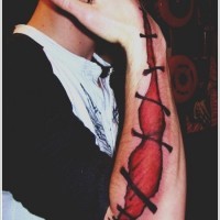 Tatuaje en el antebrazo, cicatriz de sutura aterradora