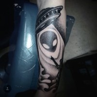 Awesome designed little black alien ship with human tattoo on arm