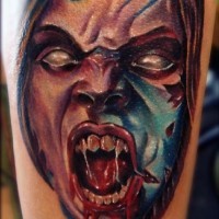 Awesome detailed and colored bloody evil monster face tattoo on arm