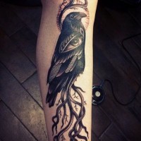 Awesome detailed black ink crow stylized with mystic eye tattoo on leg