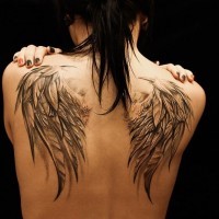 Awesome detailed realistic pair of feather wings upper back tattoo