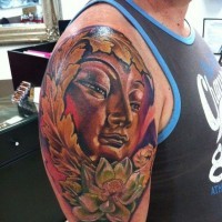 Awesome face of buddha and lotus tattoo by Fabian de Gaillande