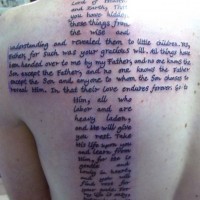 Awesome great сross consisting of text tattoo on back